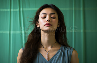Buy stock photo Young Asian woman, eyes closed on green backdrop. Religion concept.