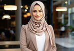 Portrait of professional muslim woman, office backdrop. Wearing hijab. Religion concept.
