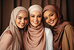 Three empowered muslim women posing. Wearing hijab and smiling. Religion concept.