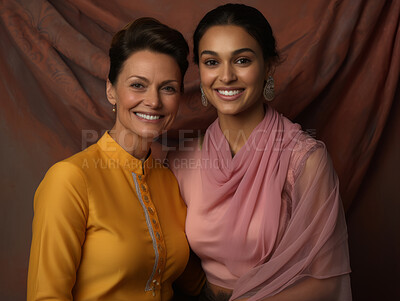 Buy stock photo Hindu mother and daughter  wearing traditional attire. Posing on backdrop.