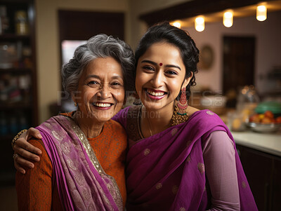 Buy stock photo Happy hindu mother and daughter  wearing traditional attire. Posing in home.