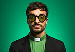 Studio portrait of young priest in fashion concept. Vibrant colour. Religion concept.