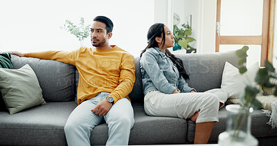 Unhappy, fight and couple angry on a couch together duo to infertility, argument and toxic relationship in a home. Conflict, divorce and man has problem with woman in a living room sofa for cheating