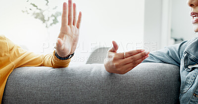 Buy stock photo Argument, hands and closeup of couple on a sofa in the living room for cheating, fight or toxic relationship. Conversation, discussion and zoom of man and woman talking for communication at home.