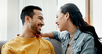 Conversation, funny and couple on sofa in home living room, bonding and having fun. Smile, communication of man and woman in lounge for healthy connection of love, happy or laughing together in house