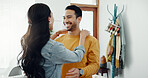 Couple, happy and hug in home lounge with a smile, security and love in healthy relationship. Young man and woman together in an apartment for affection, forehead touch and communication with care