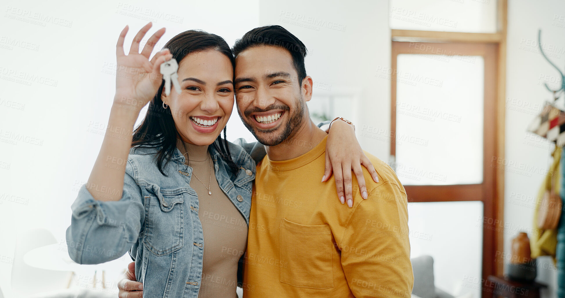 Buy stock photo New home keys, hug and portrait of happy couple moving into house, real estate property or apartment purchase. Love, homeowner smile and Mexican man, woman or relocation people embrace in living room