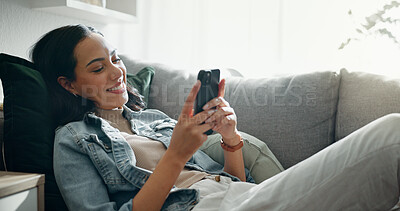 Buy stock photo Woman, phone texting and home with social media post, networking and online on a sofa. Mobile app, happy message and typing on a living room couch with digital entertainment and tech in a house