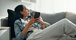Woman, thinking and typing on smartphone on sofa, scroll social media and reading notification at home. Cellphone, relax and search connection, download digital app and mobile contact in living room