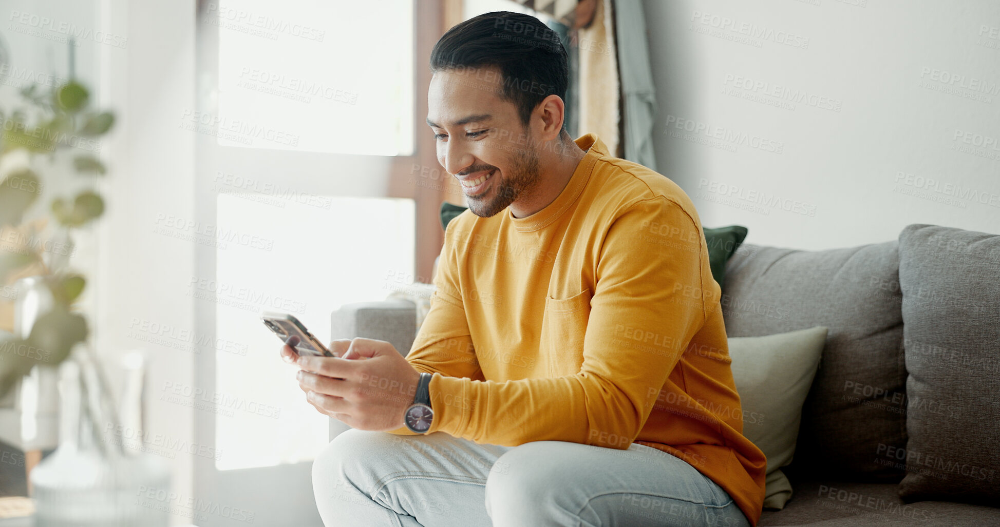 Buy stock photo Home, smile and man with a smartphone, typing and connection with social media, digital app and post. Person, mobile user or guy with a cellphone, search internet or network with contact and relax