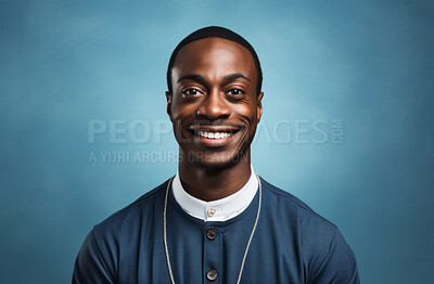 Studio portrait of african priest against blue backdrop. Religion concept.