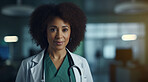 Portrait of female African American doctor standing in a hospital at night for night shift