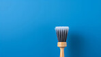 Wooden brush on blue. Clean home and kitchen copyspace background