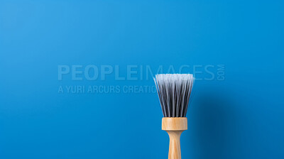 Wooden brush on blue. Clean home and kitchen copyspace background