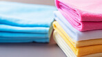 Stack of colorful folded clothing items. Clean laundry copyspace background