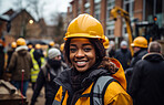 Woman construction worker  standing at building site smiling. Empowerment concept.