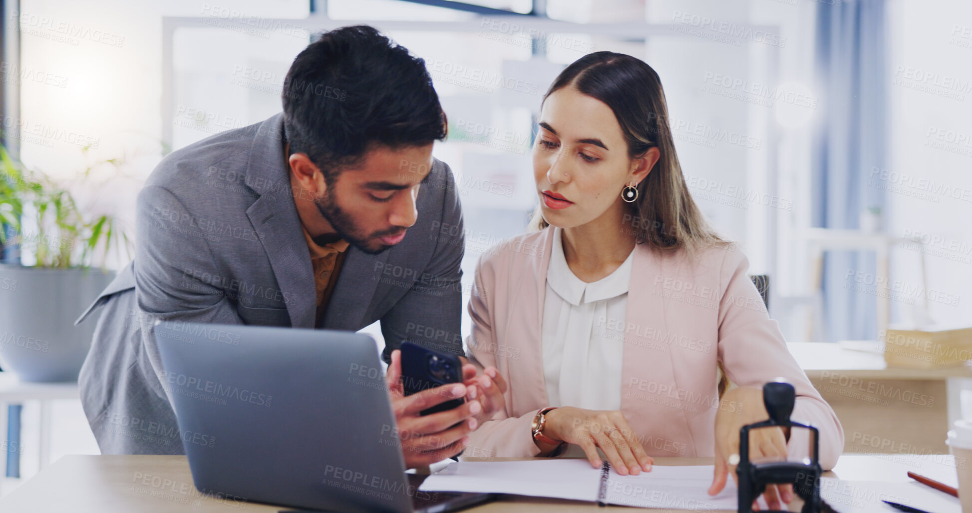 Buy stock photo Laptop, phone and review with business people in the office, working together in discussion of a text message. Collaboration, communication or feedback with a man and woman employee talking at work