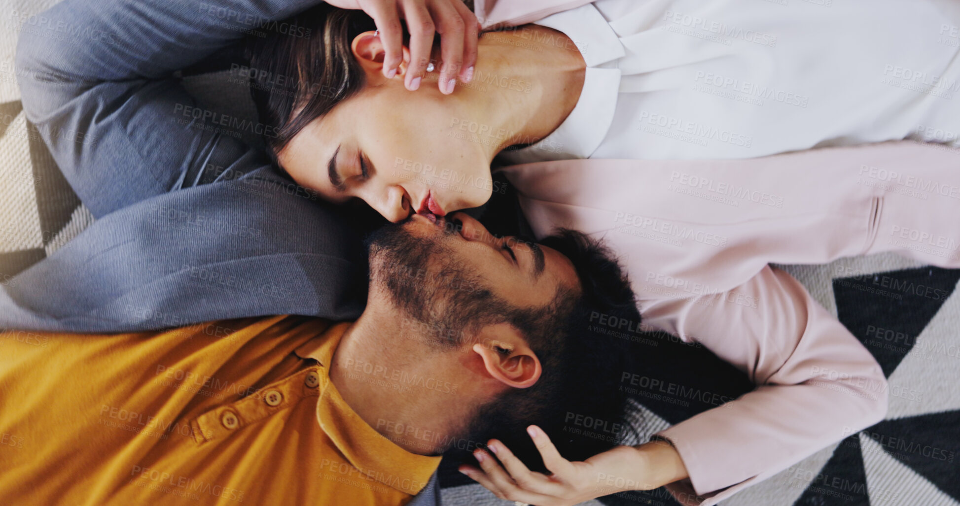 Buy stock photo Embrace, above and couple kiss on the floor for love, care and comfort in relationship. Happy, affection and a man and woman kissing for happiness, marriage and romance together with a smile