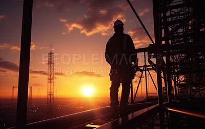 Silhouette of engineer on a construction site at sunset. Golden hour concept.