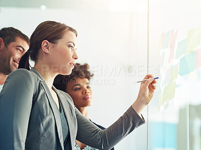 Buy stock photo Shot of a group of colleagues having a brainstorming session at work