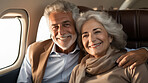 Mature couple on first class private jet. Luxury vacation travel concept.