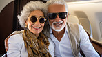 Mature couple on first class private jet. Luxury vacation travel concept.