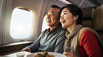 Mature couple on first class private jet. Luxury vacation travel concept.