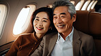 Mature couple on first class private jet. Luxury vacation travel concept.