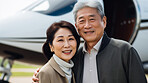 Mature couple by first class private jet. Luxury vacation travel concept.