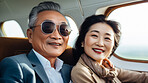 Mature couple on first class private jet. Luxury vacation travel concept.