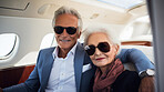 Mature couple on first class private jet. Luxury vacation travel concept.