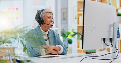 Consultant, senior woman and talking with technology at office for customer service at help desk call center. Sales, telemarketing and mature employee with headphones at work for crm with technical support.