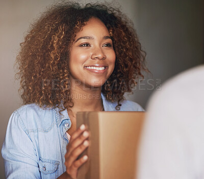 Buy stock photo Cropped shot of a woman receiving her package from the delivery man