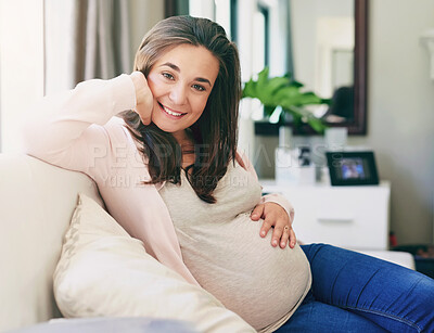 Buy stock photo Shot of a young pregnant woman relaxing at home