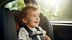Toddler child sitting in car seat. Portrait of a child strapped in car seat for safety concept