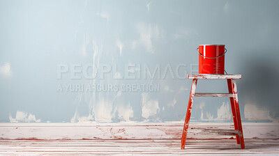Stool with paint bucket on it against wall. Copy space, diy construction concept.