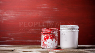 Open used paint tubs on red backdrop. Copy space, Renovation concept.