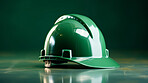 Studio shot of green hard hat on blank backdrop. Labor day Concept. Construction concept.