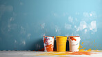 Opened paint buckets, Paint splashed against wall. Copy space. DIY construction concept.