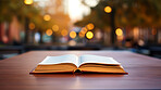 Religious book laying open on outdoor table. Religion and faith concept.