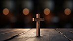 Close up of small wooden cross on table. Religion and faith concept.