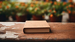 Religious book laying on outdoor table. Blank cover. Religion and faith concept.