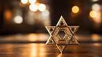 Close up of star of David on table. Copy space. Religion and faith concept.