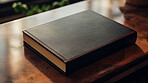 Religious book laying on table. Blank cover. Religion and faith concept.