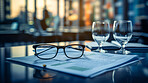 Glasses on table with financial documents. City background. Stock market concept.