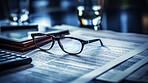 Glasses on table with financial documents. City background. Stock market concept.