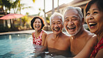 Senior friends in swimming pool. Active holiday fun, fitness and longevity