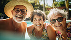 Senior friends in swimming pool. Active holiday fun, fitness and longevity