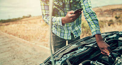Buy stock photo Cropped shot of a young man checking his engine oil after breaking down