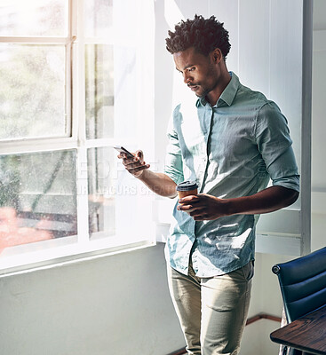 Buy stock photo Cropped shot of a young designer texting on his cellphone in an office